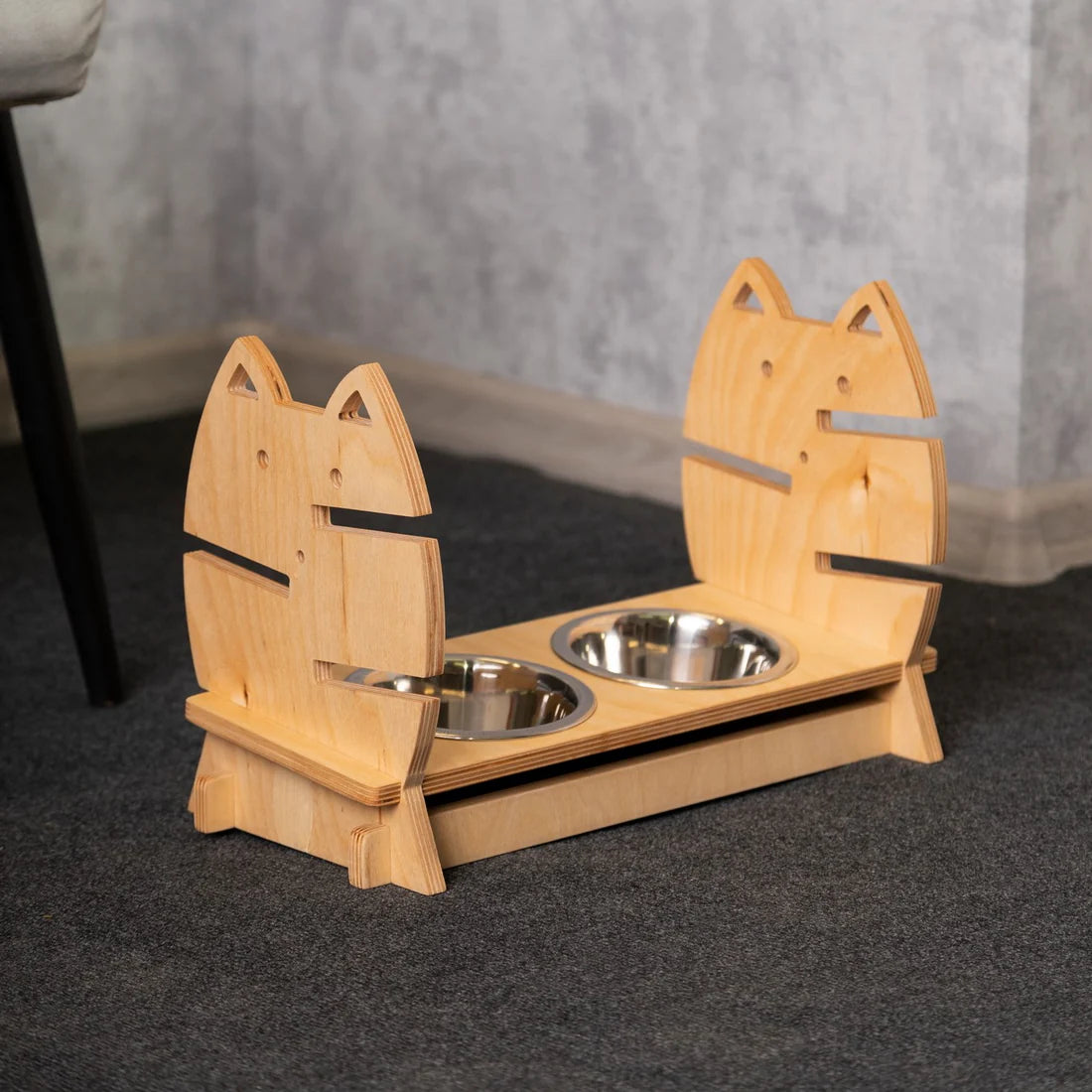 Sleek and modern elevated cat feeder made of light wood, featuring two stainless steel bowls.